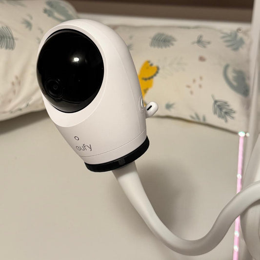 Eufy camera connected to a white flexible mounting arm through a black Aureli adapter; camera and arm are not included.